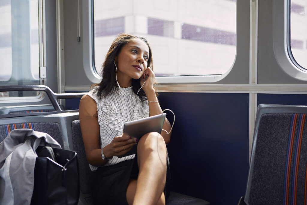 Businesswoman using digital tablet on train