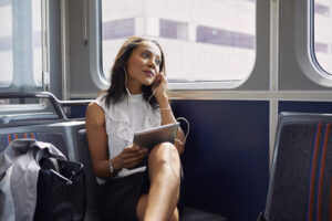 Businesswoman using digital tablet on train